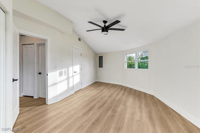 unfurnished room with electric panel, light wood-style flooring, baseboards, lofted ceiling, and ceiling fan