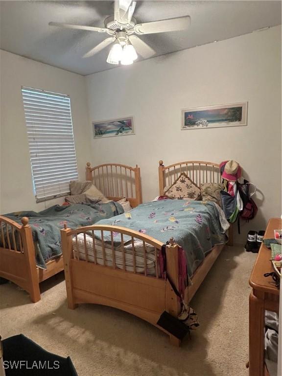 carpeted bedroom with a ceiling fan