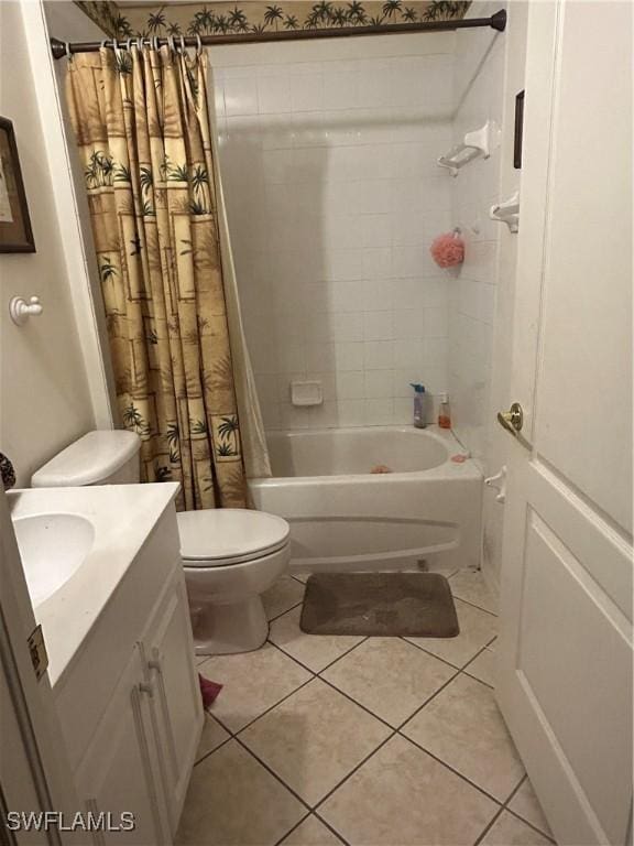 full bath featuring toilet, shower / bath combo, vanity, and tile patterned flooring