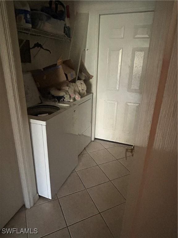 washroom with laundry area and light tile patterned flooring