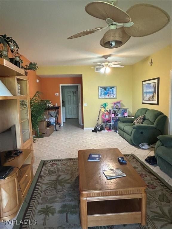 living room featuring light tile patterned flooring and ceiling fan