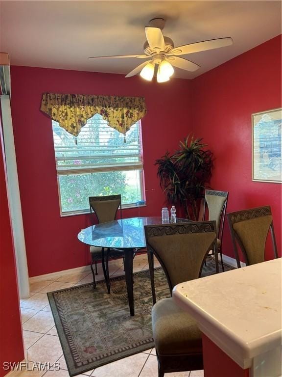 dining space featuring light tile patterned floors and ceiling fan