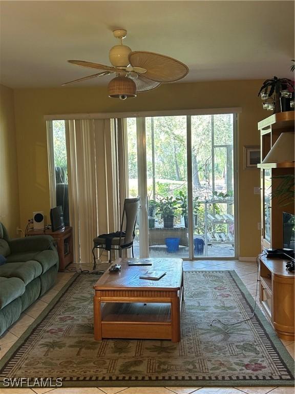 tiled living room featuring ceiling fan