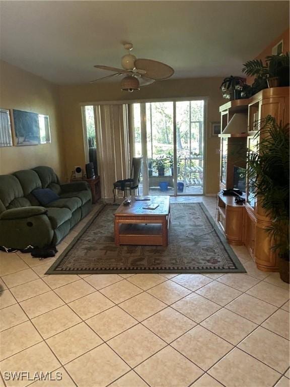 living room with light tile patterned floors, ceiling fan, and vaulted ceiling