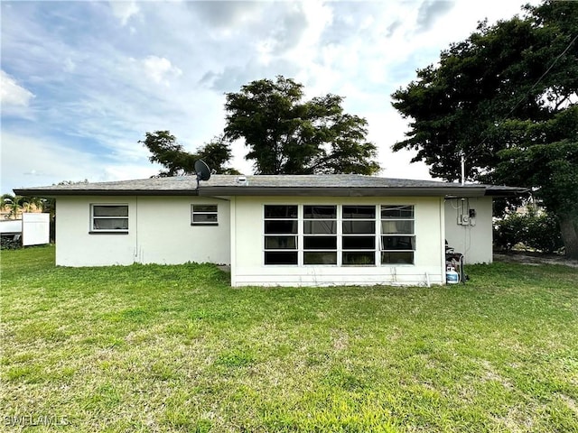 back of house with a yard