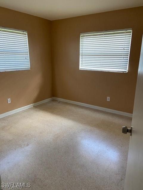 spare room with a healthy amount of sunlight and baseboards