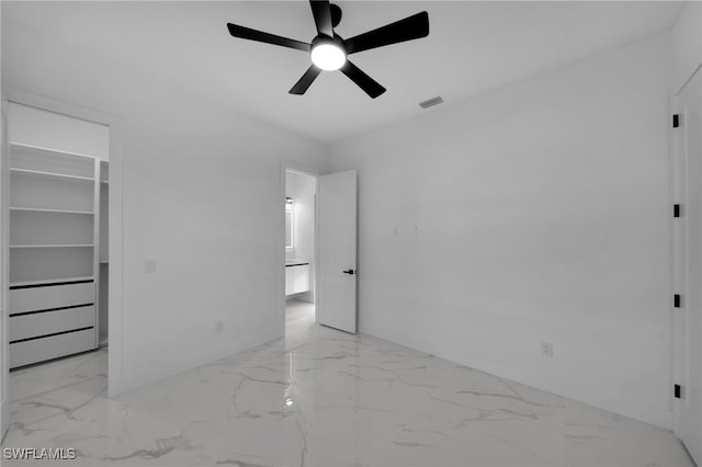 310 SW 31st Ter, Cape Coral, FL 33914 - unfurnished bedroom featuring baseboards, visible vents, ceiling fan, a walk in closet, and marble finish floor