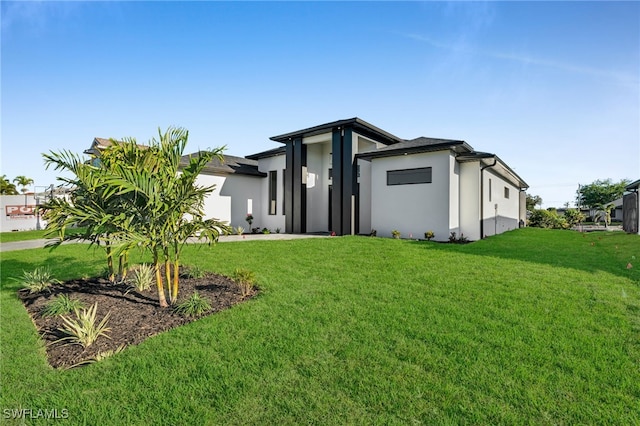 310 SW 31st Ter, Cape Coral, FL 33914 - view of front of home featuring a front lawn and stucco siding