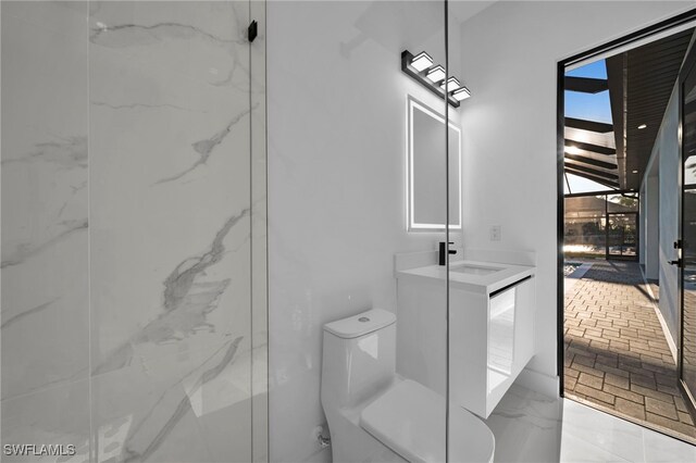 310 SW 31st Ter, Cape Coral, FL 33914 - bathroom with marble finish floor, toilet, and vanity