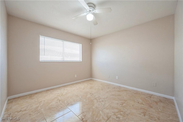 unfurnished room featuring a ceiling fan and baseboards