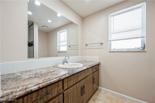 bathroom with vanity and baseboards