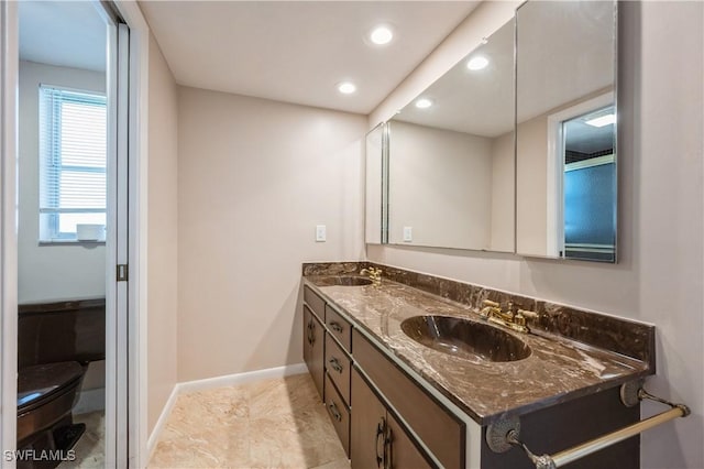 bathroom featuring double vanity, recessed lighting, baseboards, and a sink