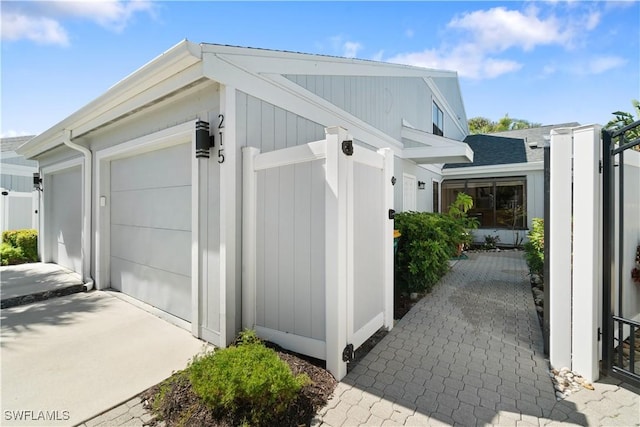 view of side of property with a garage and driveway