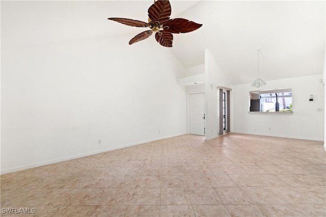 empty room featuring a ceiling fan, baseboards, and high vaulted ceiling