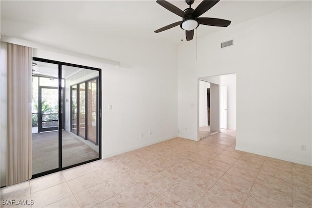 tiled empty room featuring visible vents, baseboards, and ceiling fan