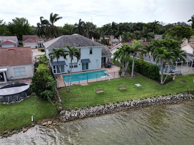 pool featuring a lawn and a water view