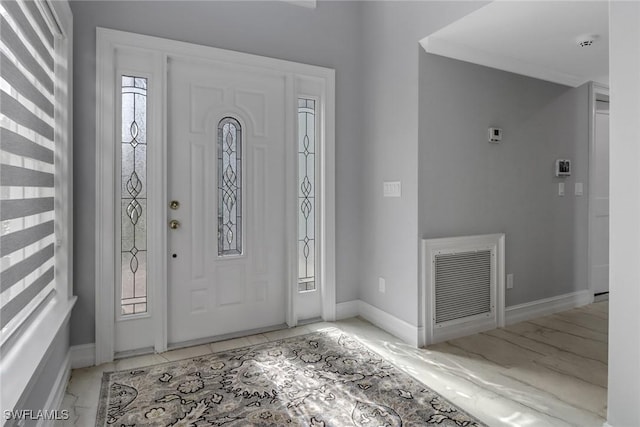 foyer with visible vents, baseboards, and marble finish floor