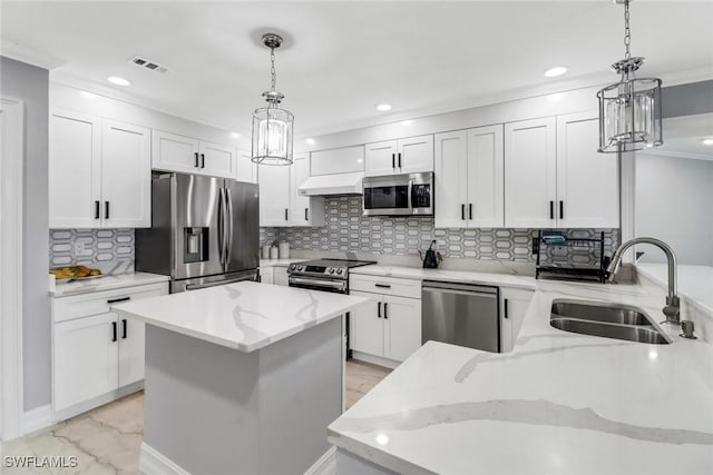 kitchen with light stone countertops, appliances with stainless steel finishes, white cabinets, marble finish floor, and a sink