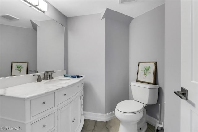 half bathroom featuring vanity, toilet, visible vents, and baseboards