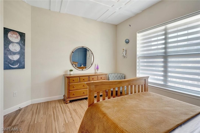 bedroom featuring light wood-type flooring and baseboards