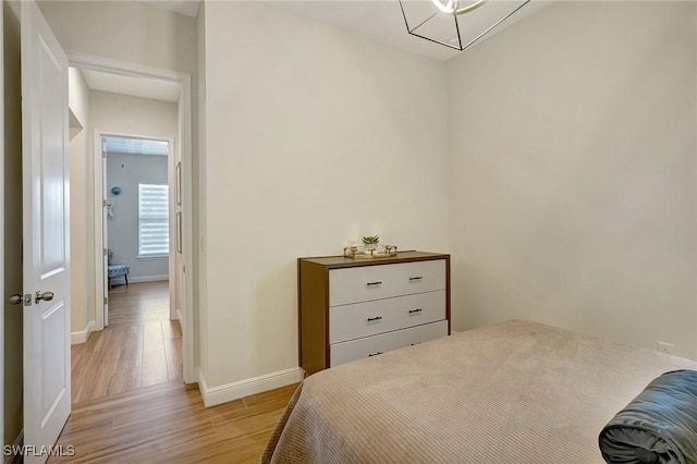 bedroom featuring light wood-type flooring and baseboards