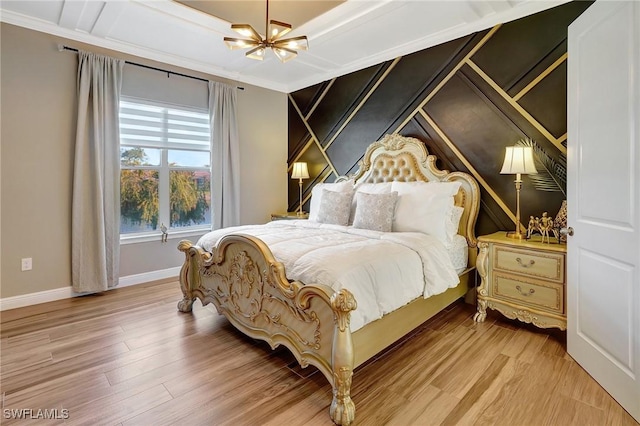 bedroom with baseboards, an inviting chandelier, crown molding, and light wood finished floors