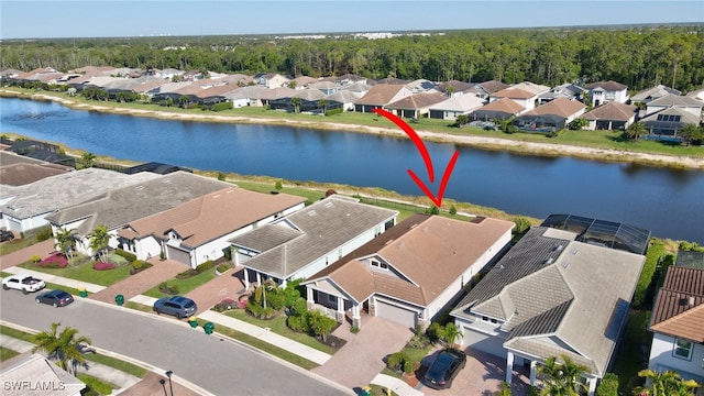 drone / aerial view featuring a residential view and a water view