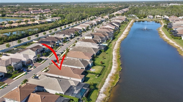 drone / aerial view featuring a residential view and a water view