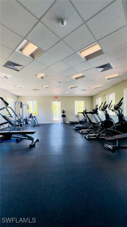 workout area featuring a paneled ceiling and visible vents