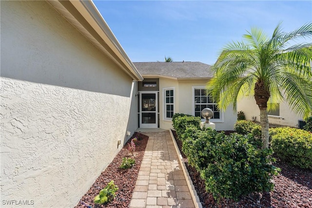 doorway to property with stucco siding