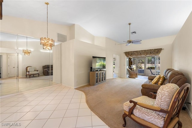 tiled living room featuring carpet flooring, ceiling fan with notable chandelier, visible vents, and high vaulted ceiling