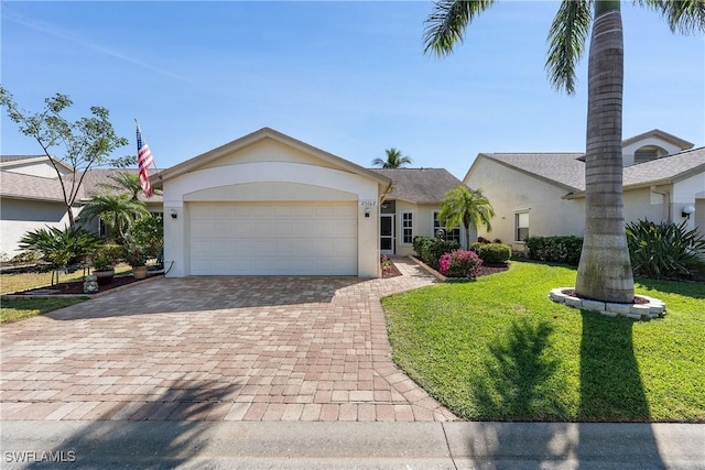 view of front of home with stucco siding, decorative driveway, and an attached garage