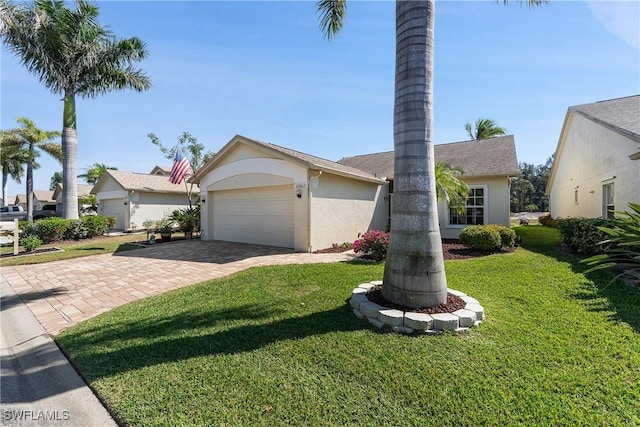 view of front of property with stucco siding, an attached garage, decorative driveway, and a front lawn