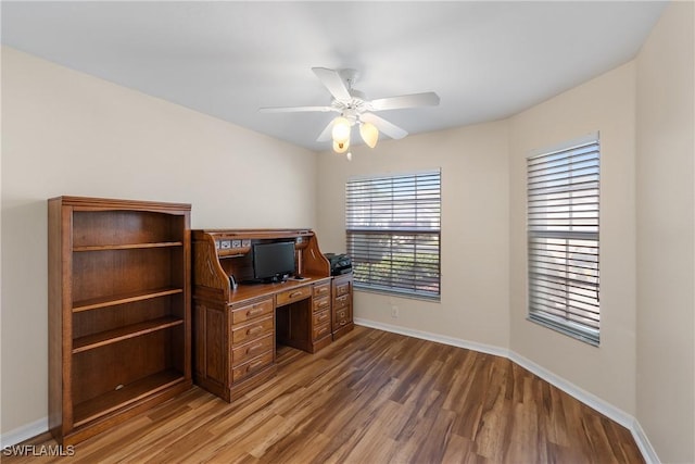 office area featuring ceiling fan, baseboards, and wood finished floors