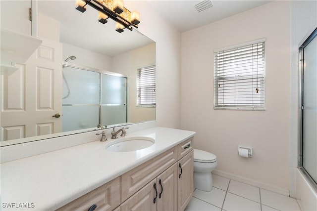 bathroom with visible vents, toilet, tile patterned floors, an enclosed shower, and vanity