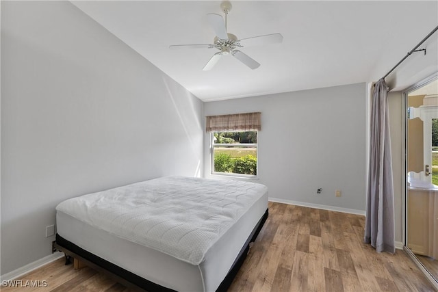 bedroom with ceiling fan, baseboards, and wood finished floors