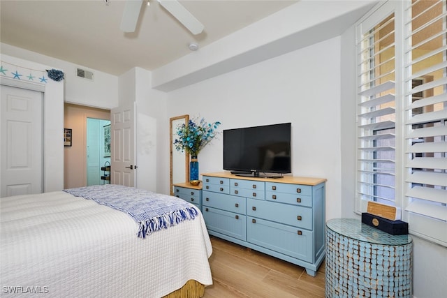 bedroom with visible vents, light wood-style flooring, and a ceiling fan