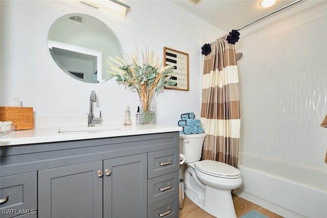 full bathroom featuring vanity, wood finished floors, visible vents, shower / bath combo, and toilet