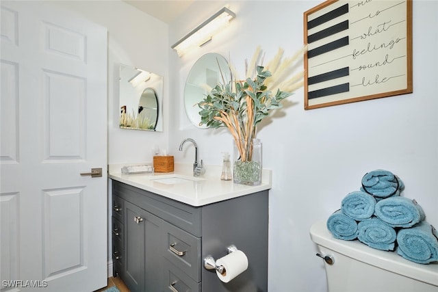 bathroom featuring vanity and toilet