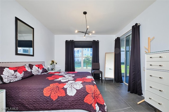 bedroom featuring dark tile patterned flooring and an inviting chandelier