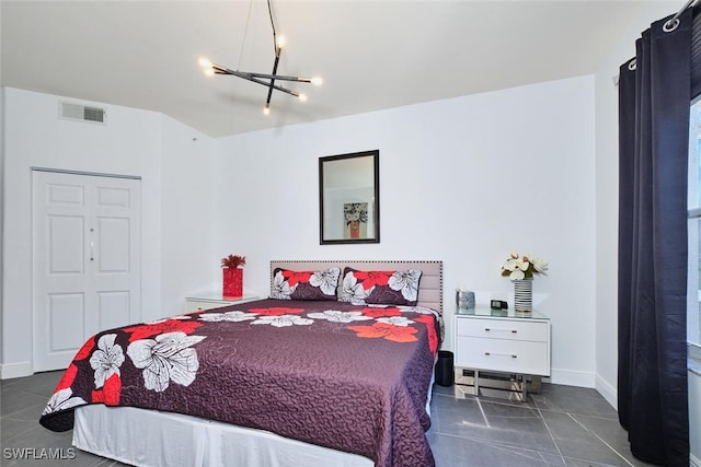 bedroom with a chandelier, visible vents, baseboards, and dark tile patterned floors