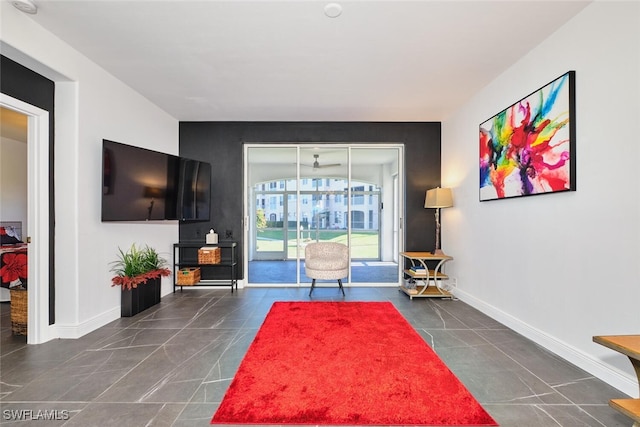 living area featuring tile patterned floors and baseboards