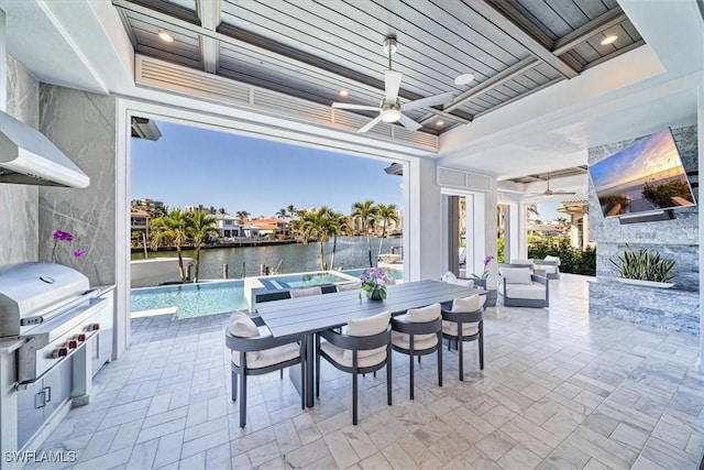 view of patio featuring an in ground hot tub, area for grilling, outdoor dining area, exterior kitchen, and ceiling fan