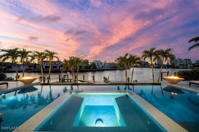 view of pool with a water view, boat lift, a dock, and a pool with connected hot tub