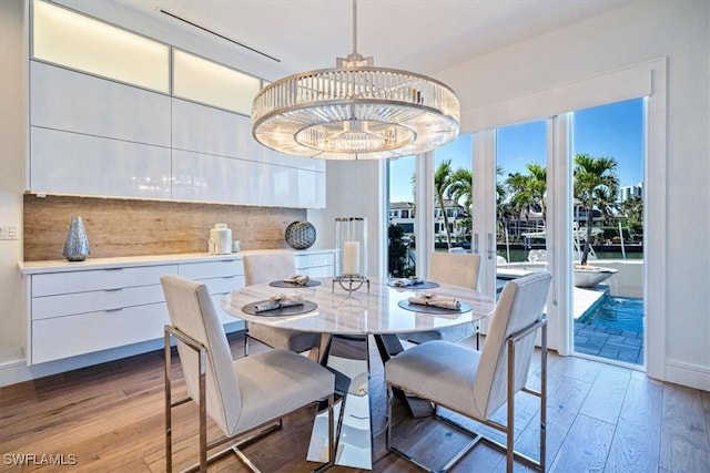 dining area with an inviting chandelier and light wood finished floors