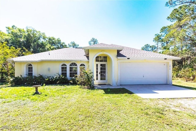 view of front of home featuring a front lawn, concrete driveway, stucco siding, french doors, and an attached garage