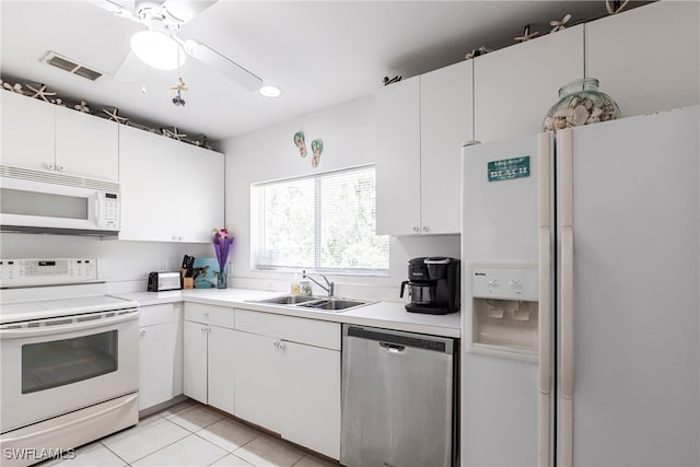 kitchen with visible vents, white appliances, light countertops, and a sink