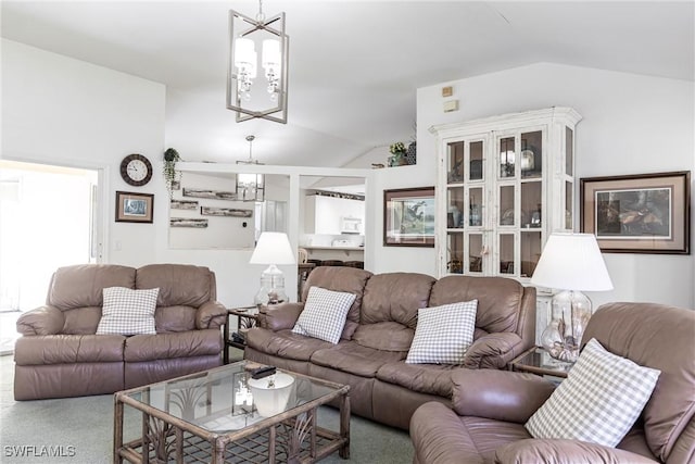 living room with a chandelier and vaulted ceiling