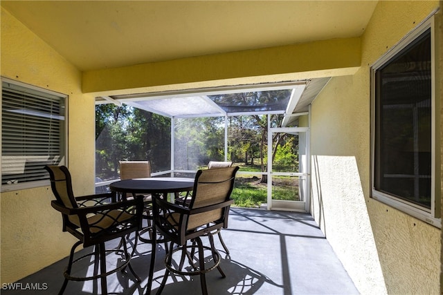 view of patio featuring a lanai