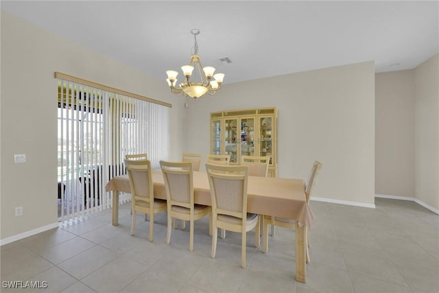 dining room featuring light tile patterned flooring, visible vents, baseboards, and a chandelier